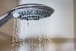 A showerhead with very low water pressure - the water is coming out like a trickle